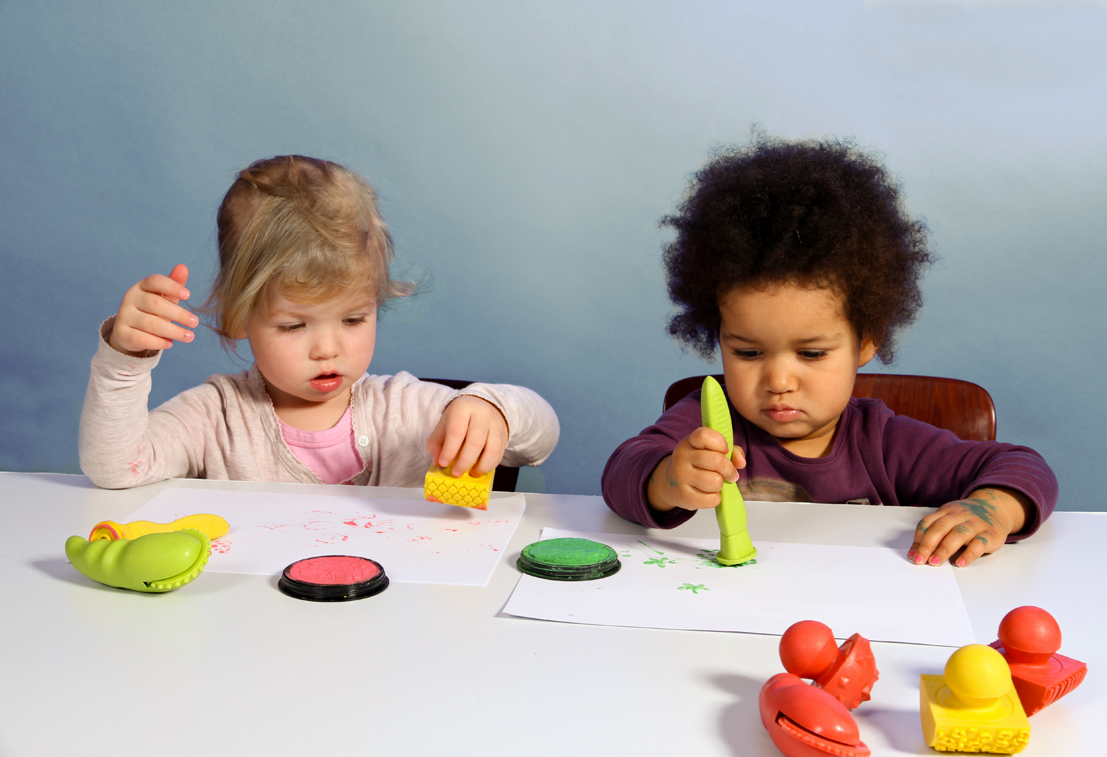 Zwei Kleinkinder stempeln mit Knetwerkzeug Zwei Kleinkinder stempeln mit Knetwerkzeug