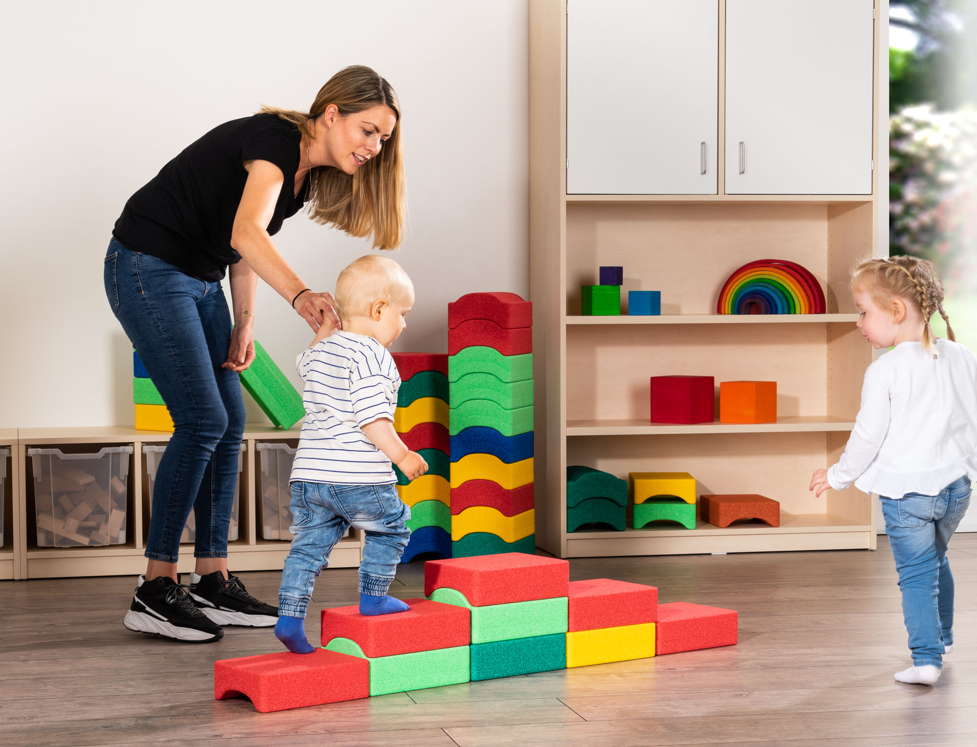 Erzieherin führt Kleinkind ber Kreativsteine Erzieherin führt Kleinkind ber Kreativsteine